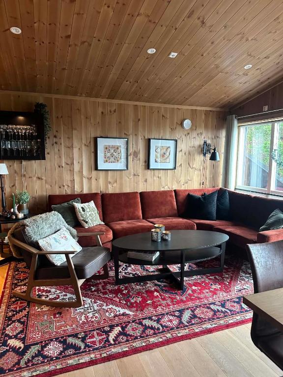 a living room with a couch and a table at Harevadet 221 in Volda
