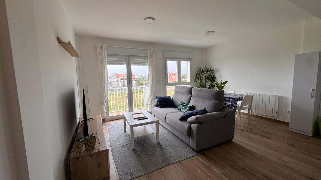 a living room with a couch and a table at AuraGalega Noro in Ribeira