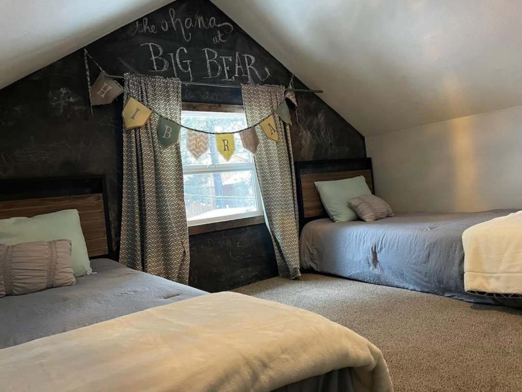 a bedroom with two beds and a sign that says be differ at THE OHANA at BIG BEAR in Big Bear City