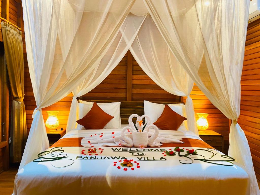 a bedroom with a bed with a bunny on it at Pandawa Villa Sidemen in Karangasem