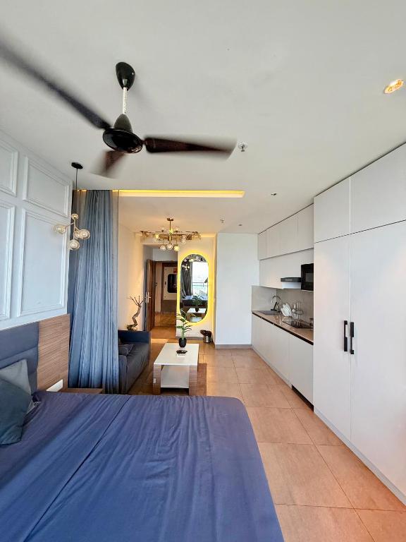 a bedroom with a blue bed and a ceiling fan at Nova Spira in Noida
