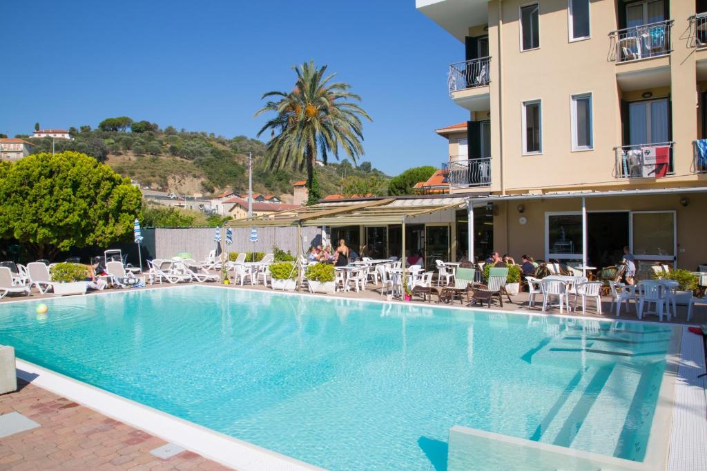a large swimming pool in front of a hotel at Hotel Delle Mimose in Diano Marina