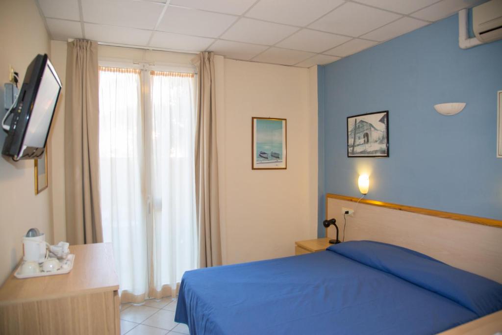 A bed or beds in a room at Hotel Delle Mimose