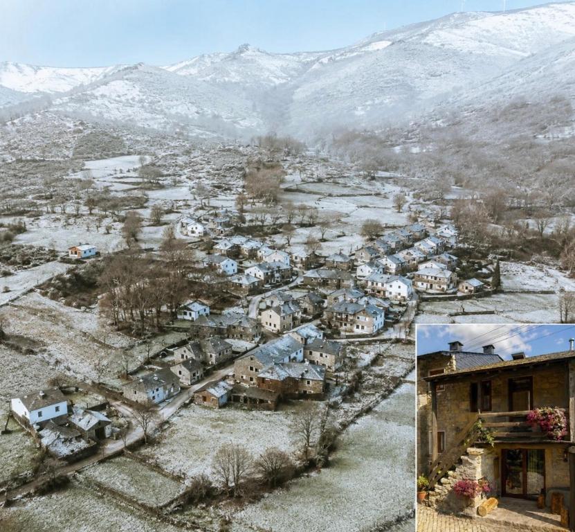 an aerial view of a village with snow covered mountains at Casa do Tio Zé Montesinho in Montezinho