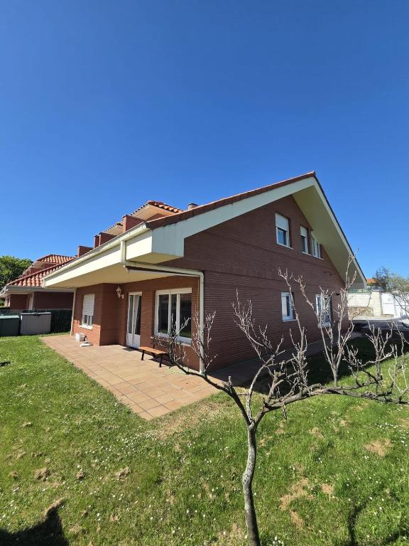a large house with a lawn in front of it at Casa el Bosque in Camargo