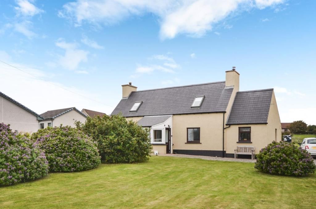 a house with a lawn in front of it at The Smithy at 52 Vatisker in Stornoway