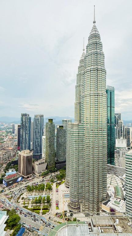 a view of a large city with tall buildings at Sky klcc by DMK luxury suites Apartment in Kuala Lumpur