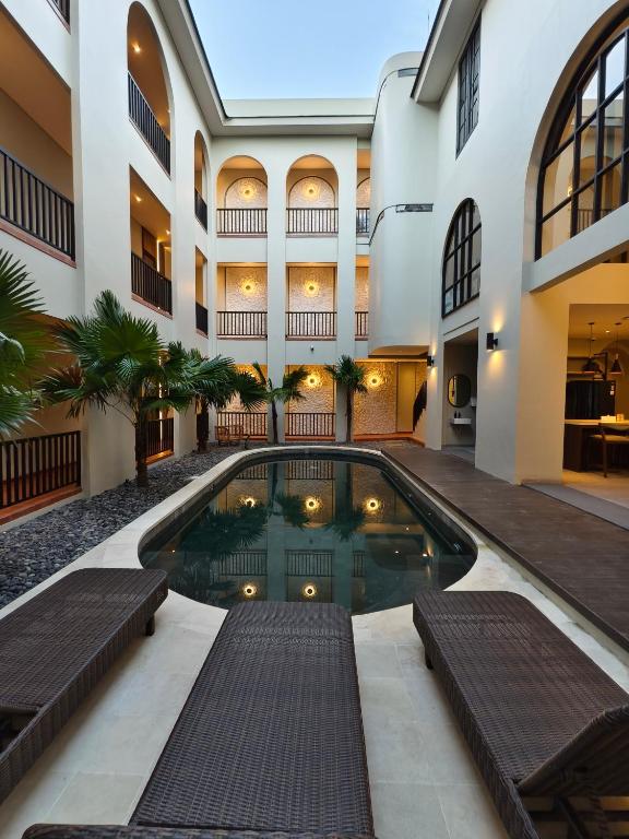 a swimming pool in the middle of a building at The Dyastana Umalas in Kerobokan