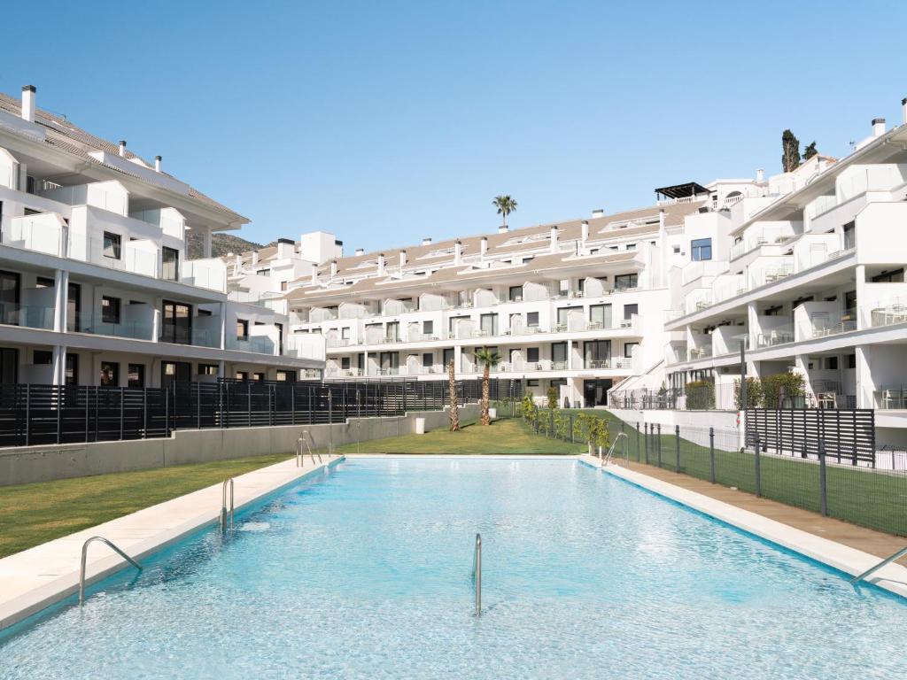 a large swimming pool in front of a building at Meral Units in Fuengirola