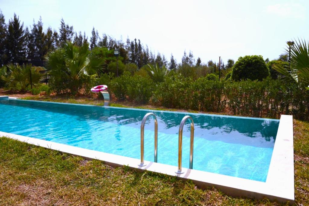 a swimming pool in the grass next to a field at Casa Biba in Utique