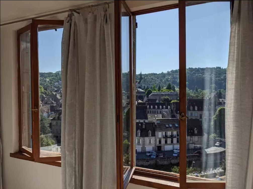 a window with a view of a city at Le Petit Perchoir à Aubusson in Aubusson