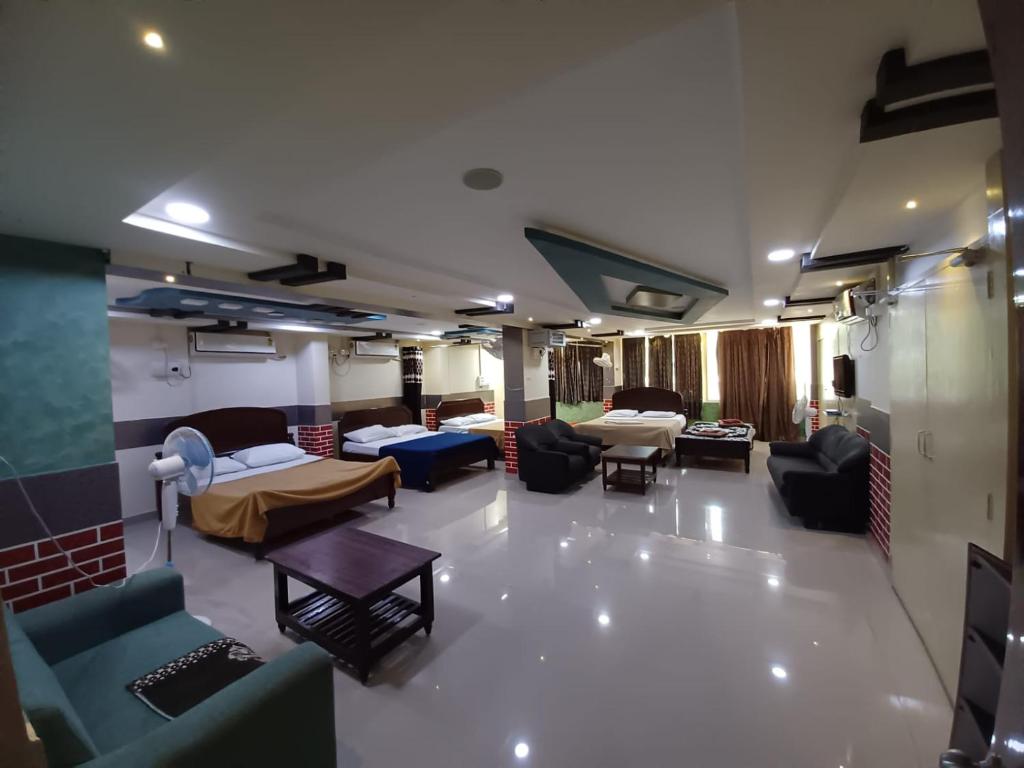 a living room with couches and beds in a room at Haritha Apartments Family-Only Apartments in Tirupati, Big Families, Groups Welcome in Tirupati
