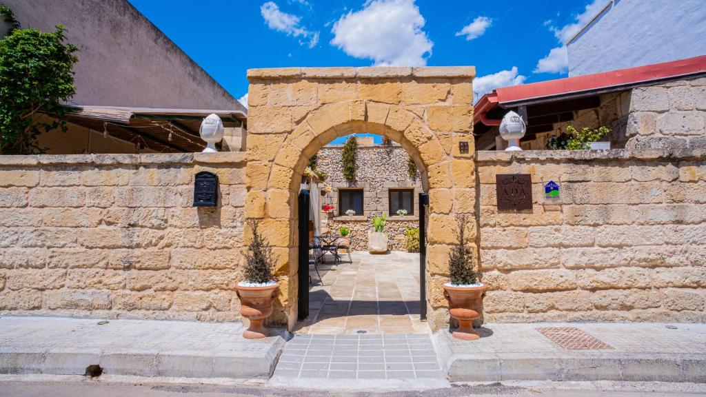 an entrance to a stone building with an archway at Salento Ada's House in Melendugno