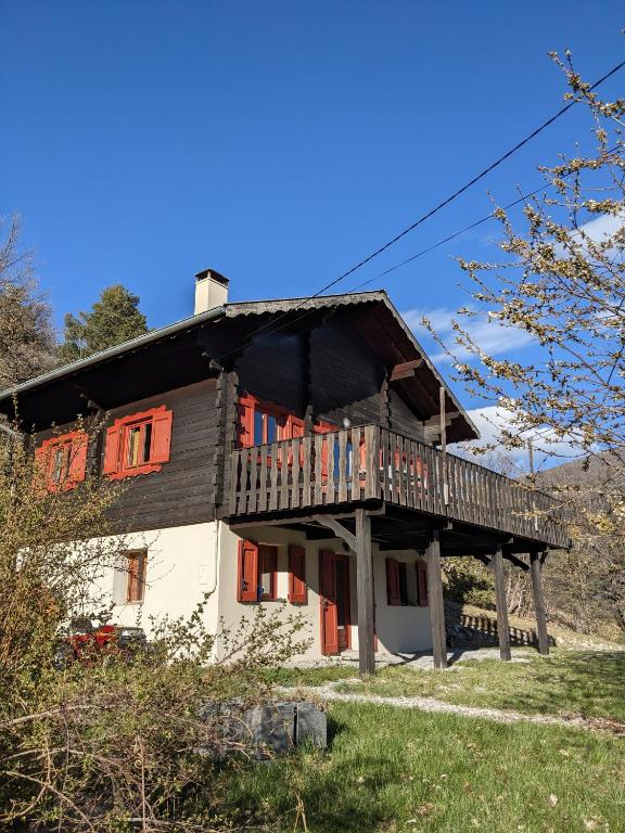 a house with a deck on the side of it at Mountain Chalet in Beauvezer in Beauvezer