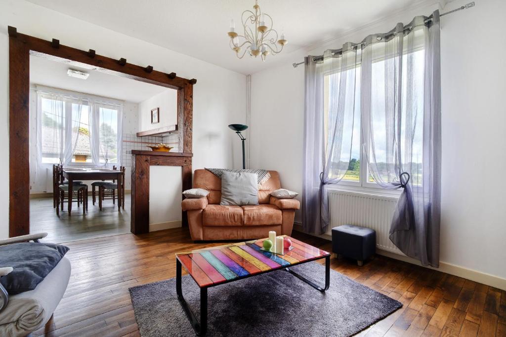 a living room with a couch and a table at Maison de vacances La Couade in Troche