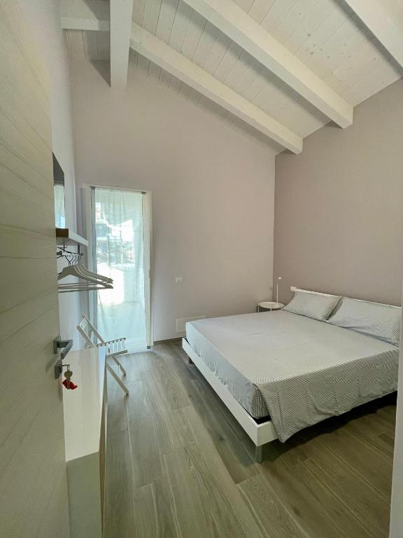 a bedroom with a bed and a large window at Villa Giovanna Rooms in Montelabbate