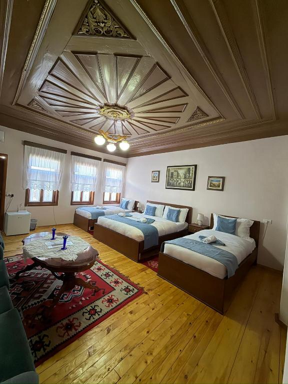 a large room with two beds and a coffered ceiling at Xhulio Guesthouse Berat in Berat
