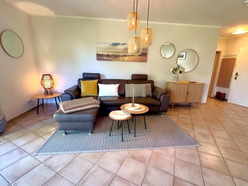 a living room with a couch and a table at Wohnpark Schmiedestraße App 18 in Wustrow