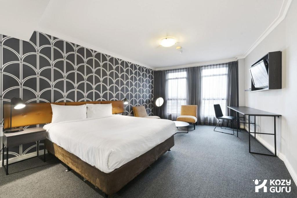 a hotel room with a bed and a desk at KozyGuru | Sydney CBD | Best Location Studio in Sydney
