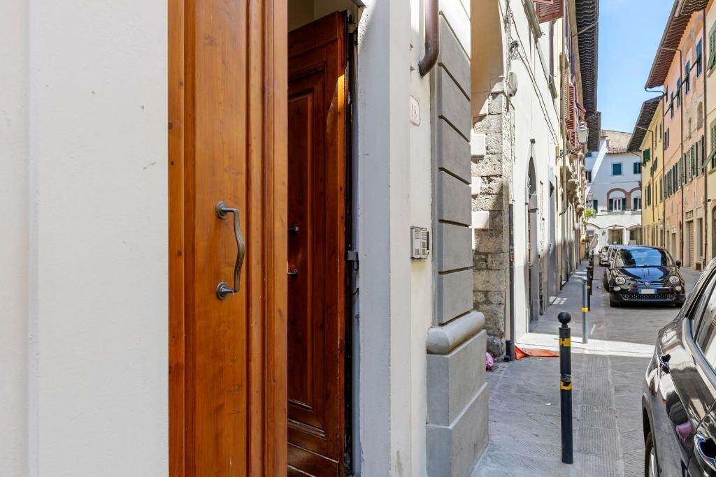 an open door to a building on a city street at Ser Lapo - Dimora storica a Prato in Prato