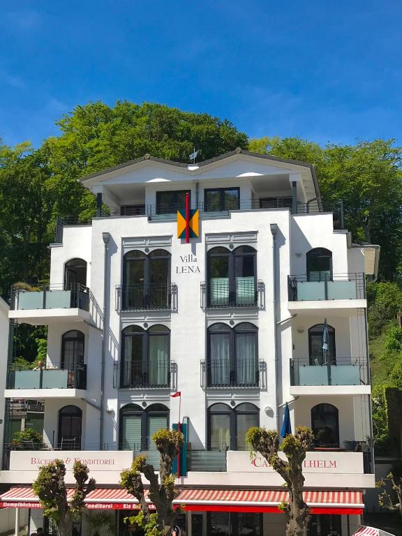 a white building with a red x on it at Villa Lena mit Fahrstuhl und Bäcker im Haus, direkt an der Flaniermeile in Ostseebad Sellin