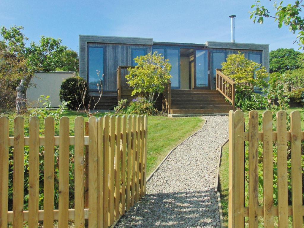 a wooden fence in front of a house at The Wooden Lodge in Byton
