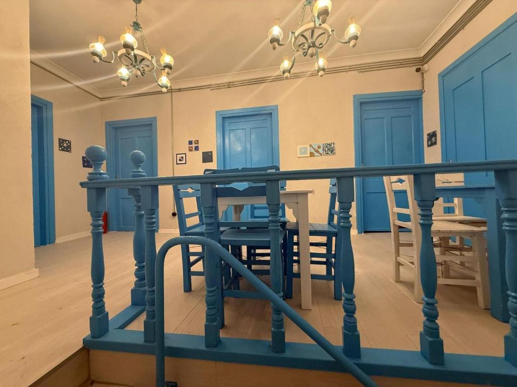 a room with a table and chairs and a chandelier at Olivento Pansiyon in Ayvalık