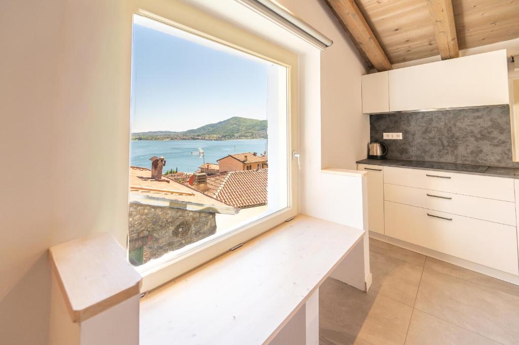 a kitchen with a large window overlooking the ocean at Predore Lake View Suites in Predore