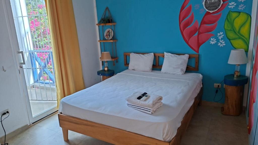 a bedroom with a bed with a towel on it at Bayahibe Essentials Rooms in Bayahibe