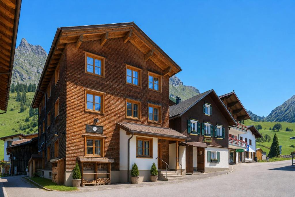 a large wooden building in the middle of a street at House Hannes Schneider Stuben in Stuben am Arlberg