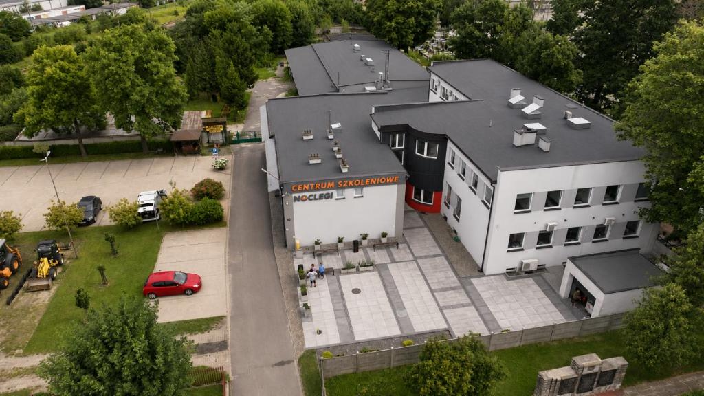 an overhead view of a white building with a parking lot at Baza noclegowa Mistral in Sieradz