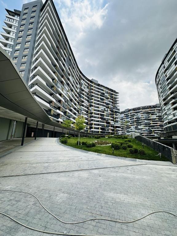a large apartment building with a chord on the ground at Green Ville Residence in Baku