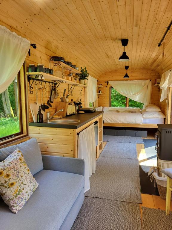 a kitchen and living room of a tiny house at Glamping Maringotka77 in Protivec