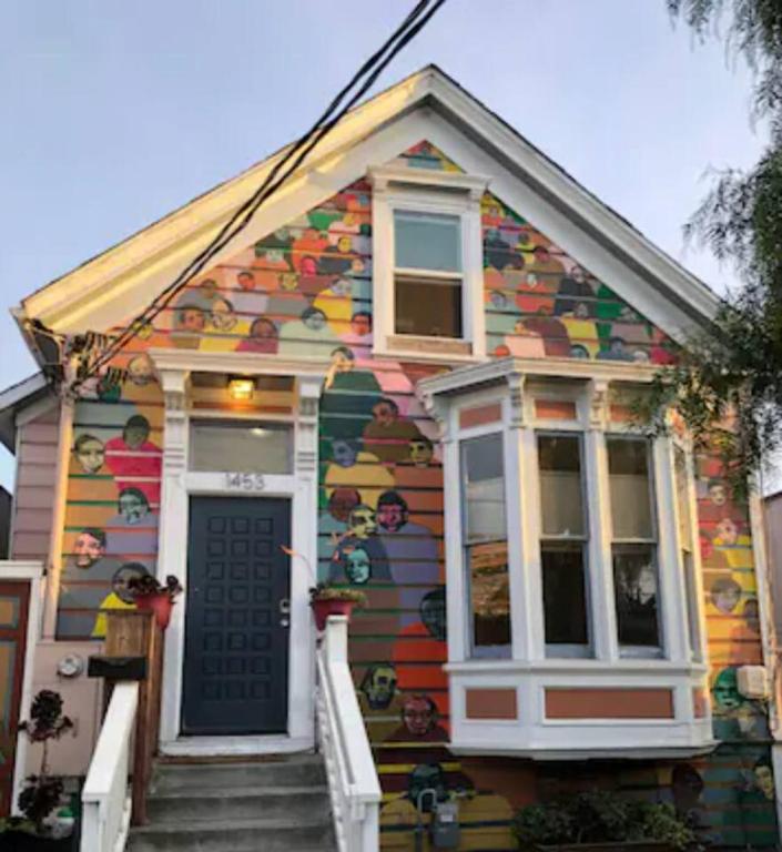a house with a painting on the front of it at Room 3 Yellow Bed 4 at Faces Oasis in Oakland