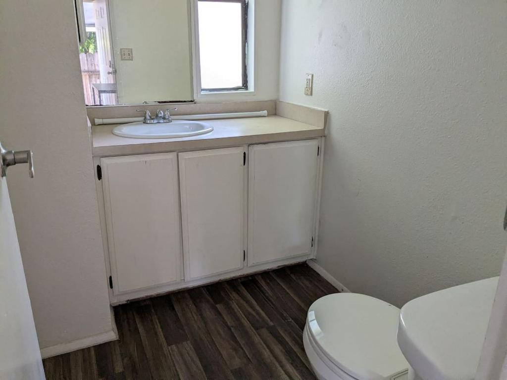a bathroom with a sink and a toilet at Faces Anex Shared Room1, Upper Bed 1 in Oakland