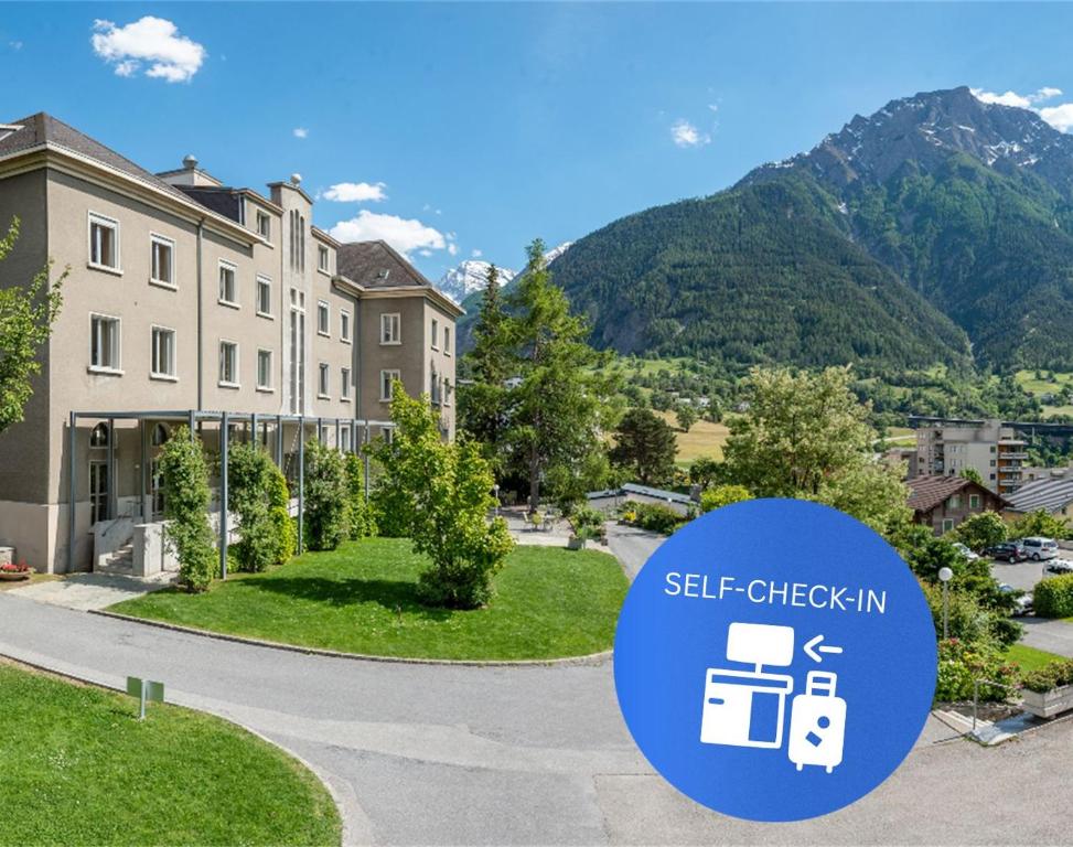 a building with a sign that reads self check in at Hotel Haus Schönstatt contactless-Check-In in Brig