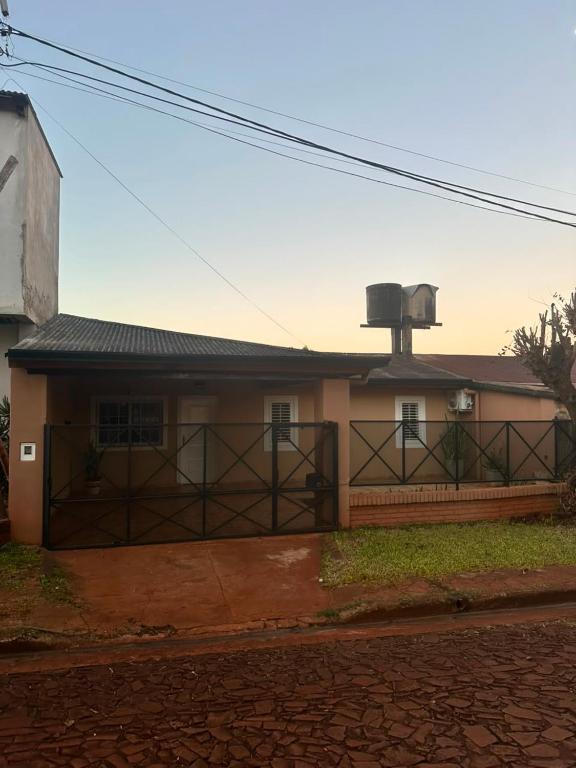 a house with a fence and a water tank on top of it at Marisol in Apóstoles