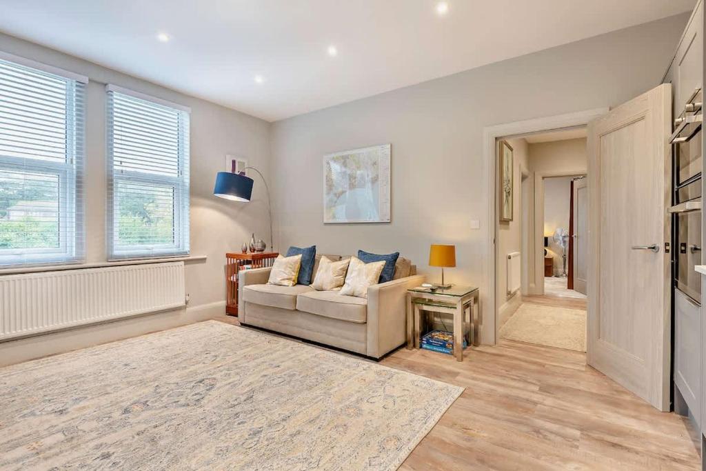 a living room with a couch and a window at Beach Walk Southbourne SOBO Beach Sleeps 4 in Southbourne