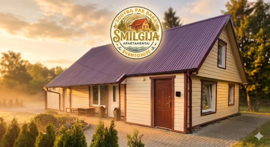 a small building with a sign on top of it at Sodyba pas Babą - Apartamentai SMILGIJA Šventoji in Palanga