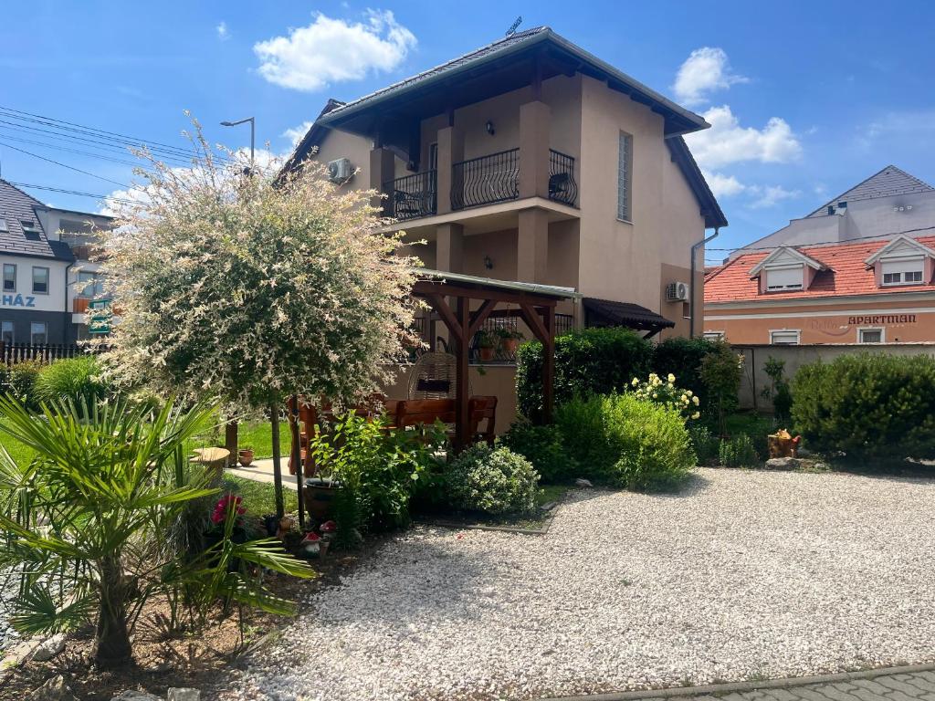 a house with a garden in front of it at Adrienn Apartman in Sárvár