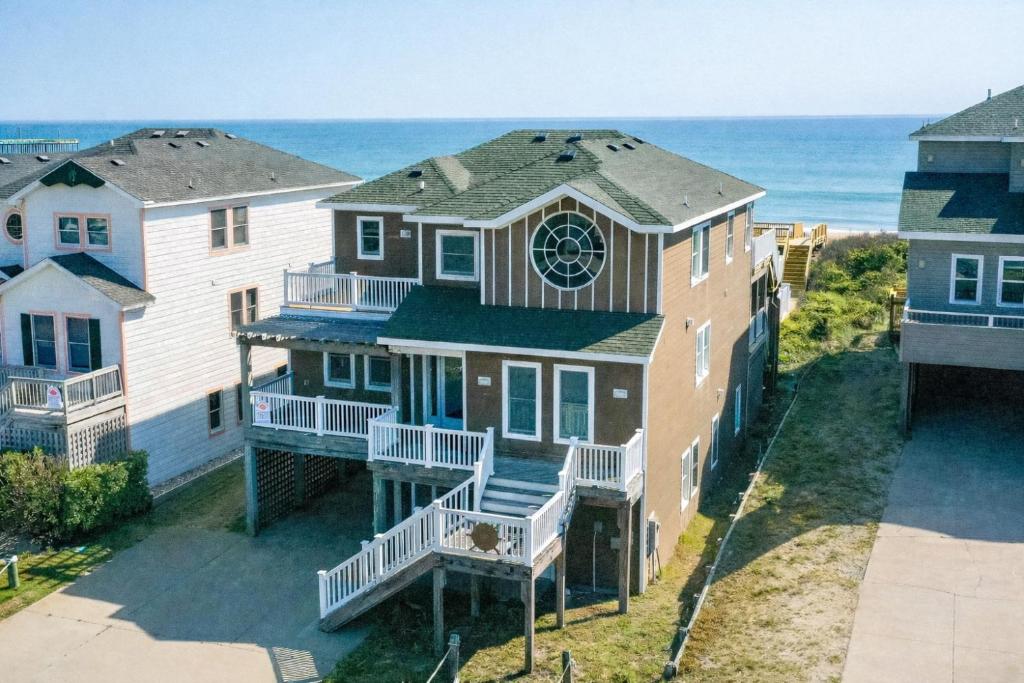 an aerial view of a house with the ocean in the background at Dream Catcher - Nags Head MP 12, Oceanfront, Elevator, Pool, Hot Tub, Pets OK, YR Flex in Nags Head