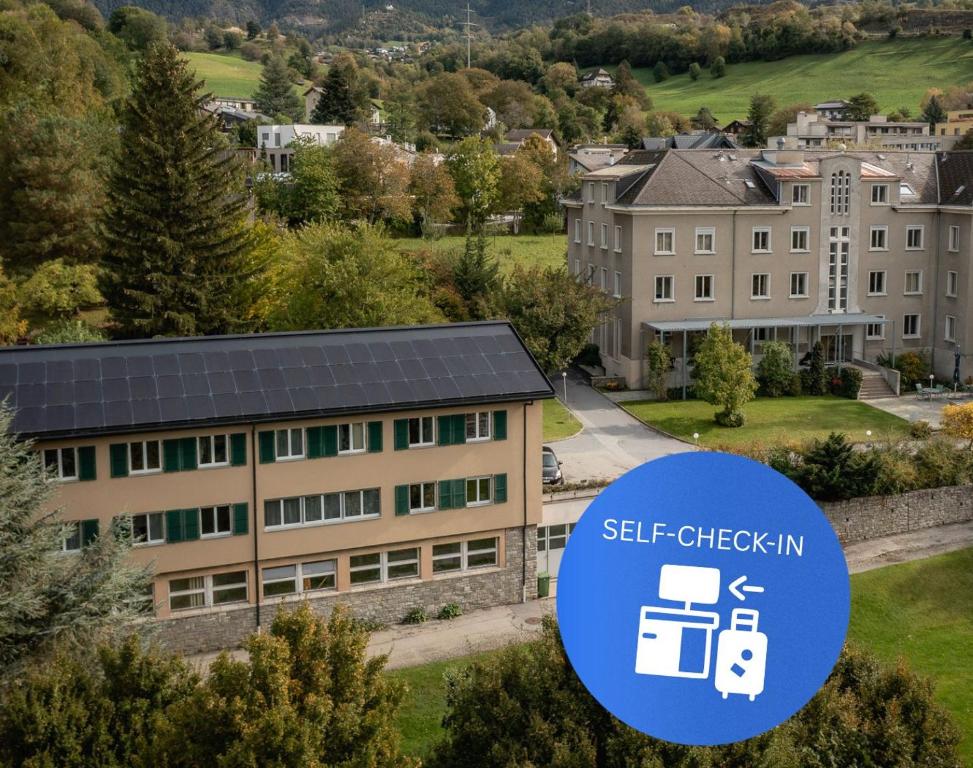 a building with a self check in sign in front of it at B&B Haus Schönstatt contactless- Check-In in Brig