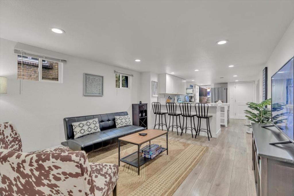 a living room with a couch and a table at Charming Washington Park Getaway in Denver