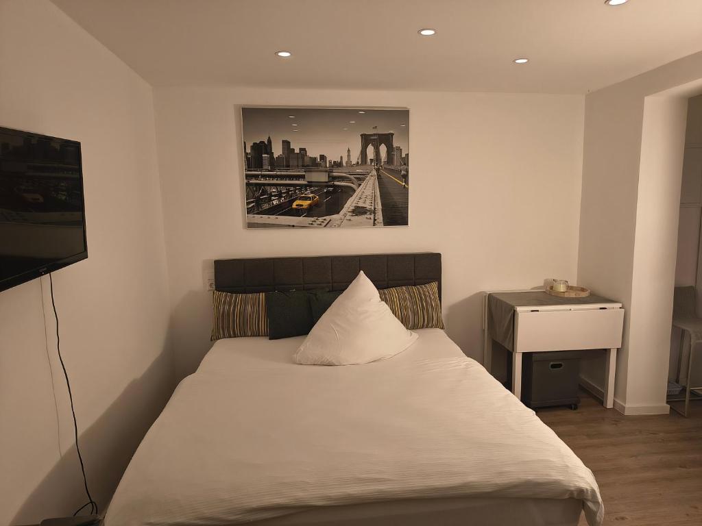 a bedroom with a bed with a picture on the wall at Appartement83 in Schwäbisch Hall