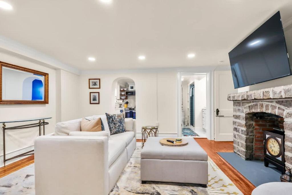 a living room with a couch and a fireplace at Garden Level 2 bed 2 bath Apartment in Historic District in Savannah