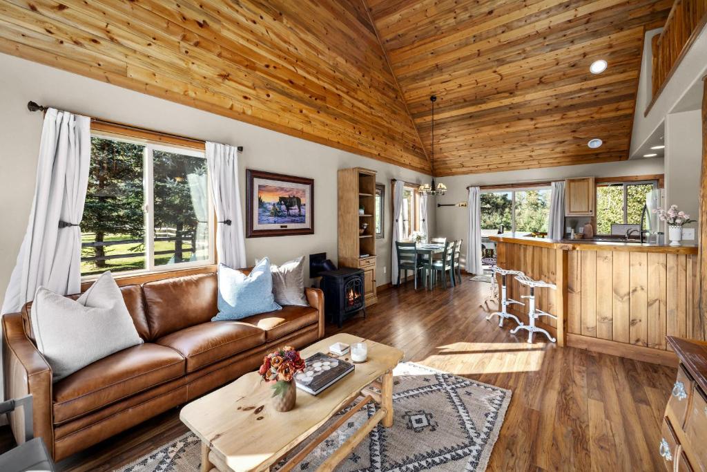 a living room with a couch and a table at Glacier River Ranch - South Fork in Columbia Falls