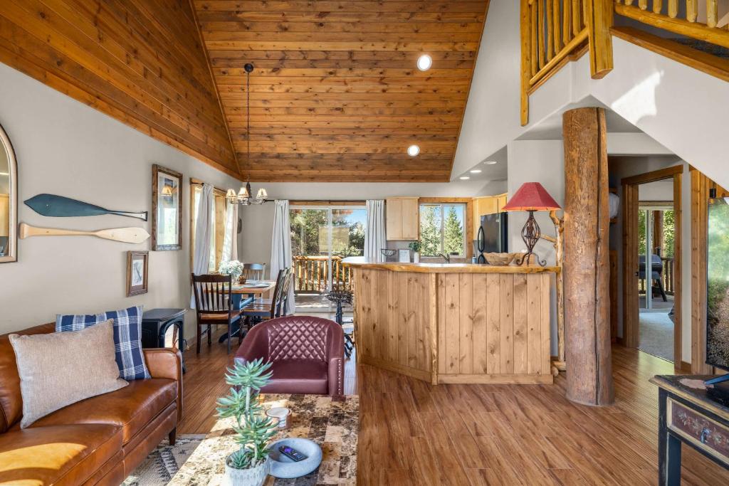 a living room with a couch and a counter in a house at Glacier River Ranch - North Fork in Columbia Falls