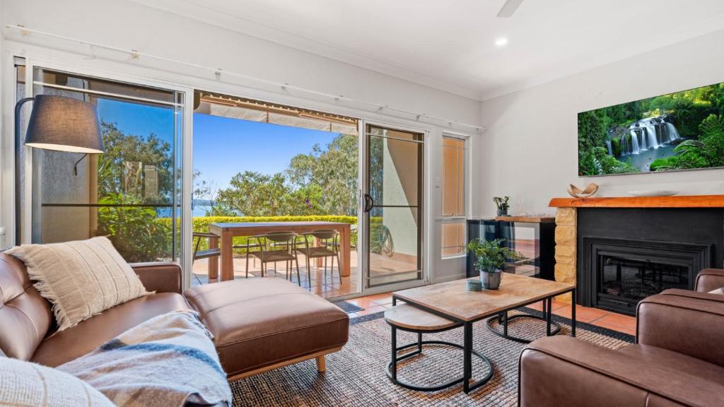 a living room with a couch and a fireplace at Tinaroo Lodge Lakeview Escape with Pool Access in Tinaroo