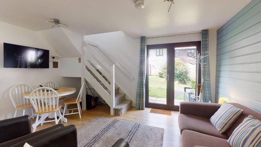 a living room with a couch and a table at 35 Strawberry Hill, Tolroy Manor in Hayle