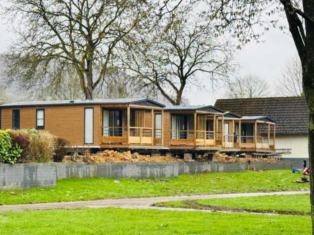 a house with a large deck in a yard at Mobile-Home Living in Gilsdorf